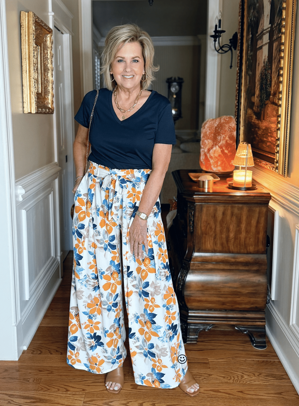 woman wearing floral palazzo pants with a navy tee